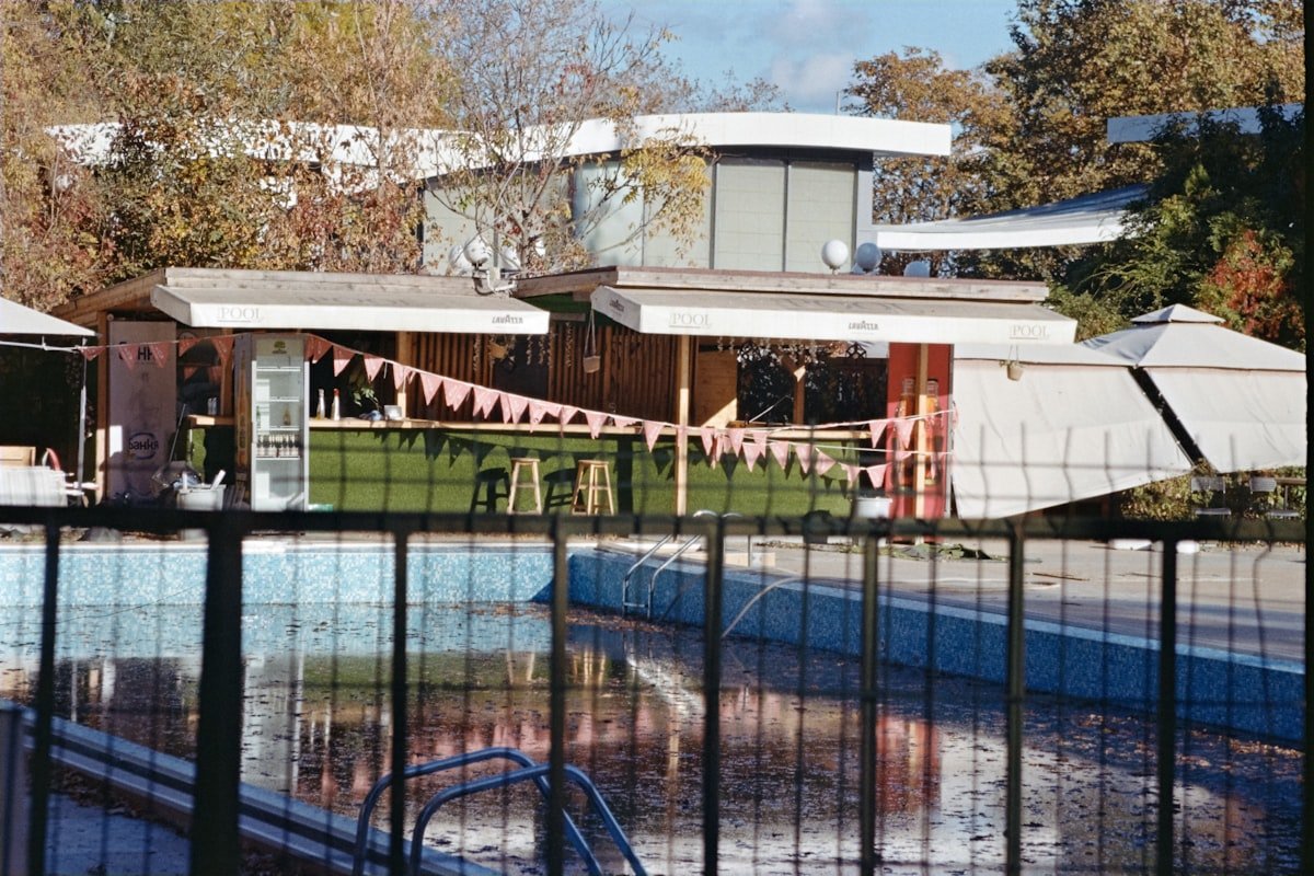 Swimming pool enclosed by a fence, illustrating a pool isolation barrier