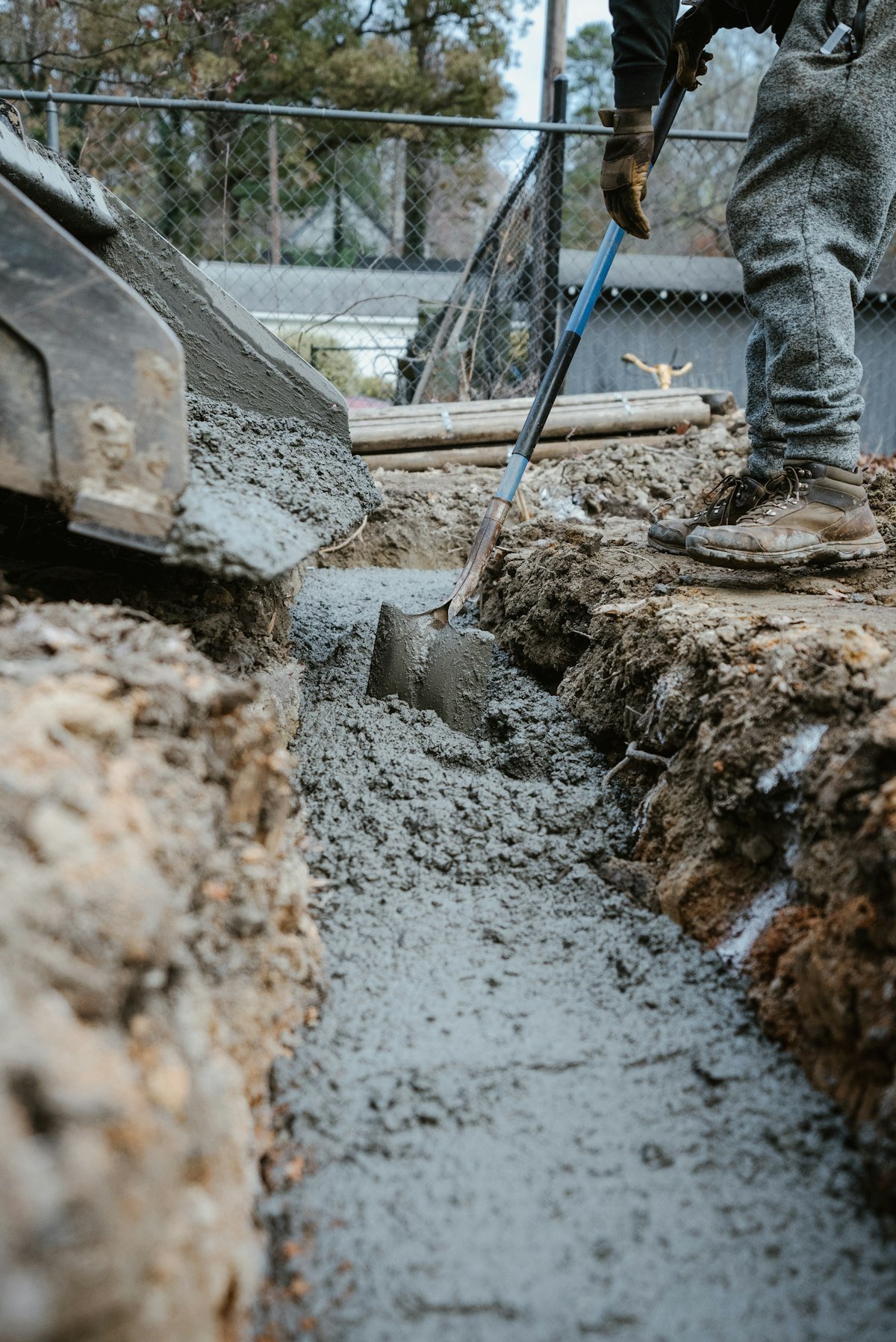 Digging and pouring a concrete footing trench along a new fence line